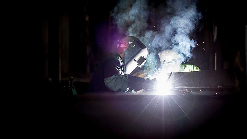 man welding a steel structure